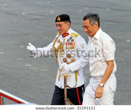 SINGAPORE - AUGUST 09: Chief Defense Force LG Desmond Kuek welcomes Prime Minister Lee Hsien Loong during Singapore National Day Parade 2009 August 09, 2009 in Singapore