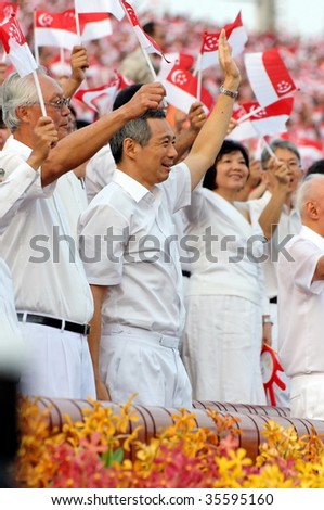 SINGAPORE - AUGUST 09: Ministers waving flags during Singapore National Day Parade 2009 August 09, 2009 in Singapore