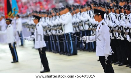 SINGAPORE - JULY 03: Guard-of-honor contingents performing presidential salute during National Day Parade Combined Rehearsal July 03, 2010 in Singapore