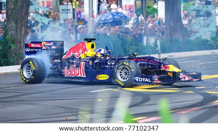 SINGAPORE - APRIL 24: David Coulthard performs donuts in the Red Bull Racing F1 car RB6 during Red Bull Speed Street Singapore on April 24, 2011 in Singapore.