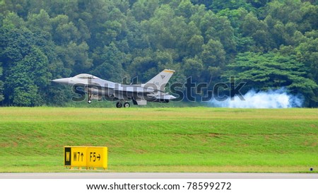 SINGAPORE - MAY 28: Republic of Singapore Air Force (RSAF) F-16C/D Fighting Falcon landing on runway during RSAF Open House 2011 on May 28, 2011 in Singapore.