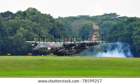 SINGAPORE - MAY 28: Republic of Singapore Air Force (RSAF) C-130 Hercules military cargo plane landing during RSAF Open House 2011 on May 28, 2011 in Singapore.
