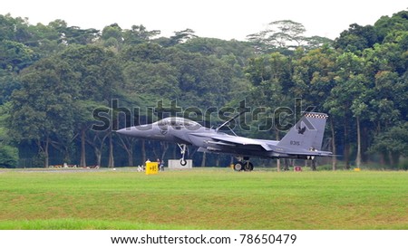 SINGAPORE - MAY 28: Republic of Singapore Air Force (RSAF) F-15SG Strike Eagle landing on runway during RSAF Open House 2011 on May 28, 2011 in Singapore.