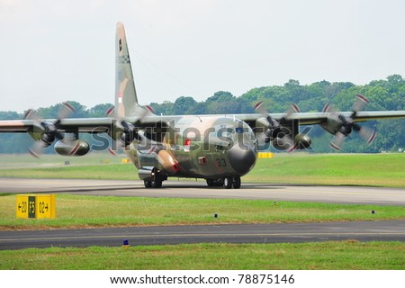 SINGAPORE - MAY 28: Republic of Singapore Air Force (RSAF) C-130 Hercules military cargo plane takes off during RSAF Open House 2011 on May 28, 2011 in Singapore.