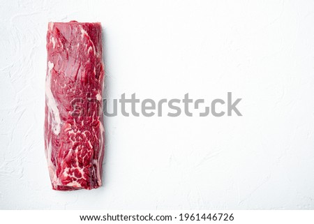 Fresh and raw beef meat. Whole piece of tenderloin with steaks set, on white stone background, top view flat lay, with copy space for text Foto d'archivio © 