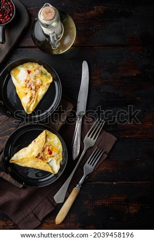 Thai  Asian omelette, fresh red chilli, brown and white crabmeat, lemon, Cheddar cheese and eggs, on frying iron pan, on dark wooden background, top view flat lay Stock fotó © 