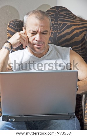 middle age man confused by his laptop