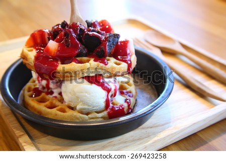 Homemade Whole-Grain Waffle Serve on Black Plastic Plate with Chocolate Cookies, Strawberries and Vanilla Ice-Cream, Topping with Strawberry Syrup