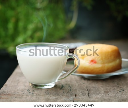 Hot milk in a glass with bread.