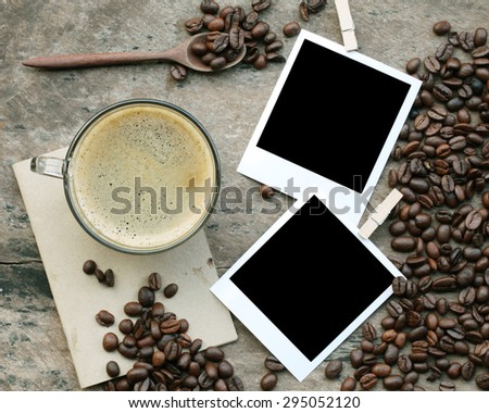 coffee cup and polaroid photo frames on wooden table.