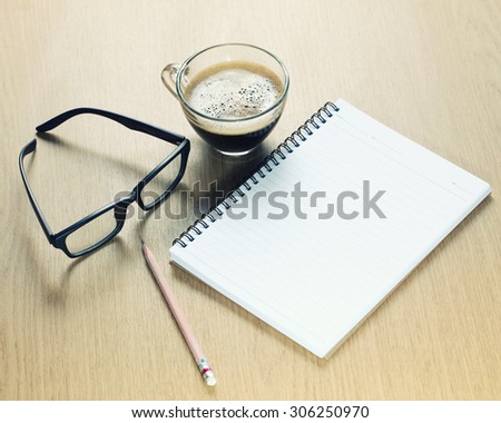 Coffee cup with Glasses ,pencil and Notepad.Take a memo.