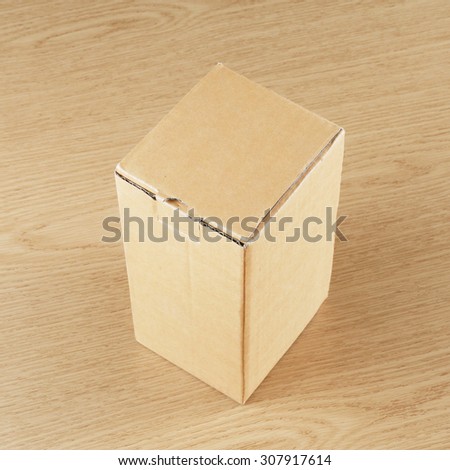 Blank brown box on wood background.