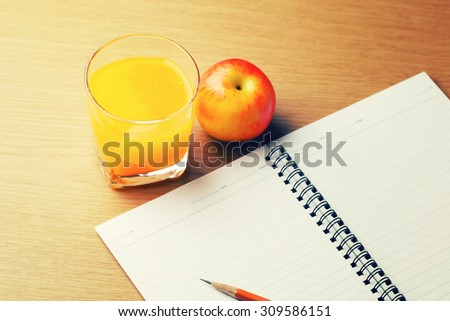Glass of orange juice with a note book - Vintage effect style pictures.