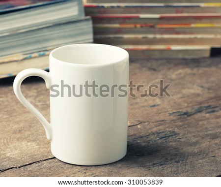 White Coffee cup on wooden table.Coffee to eat Read more.Vintage effect style.