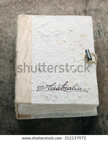 The old note book on old wooden table.