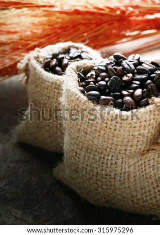 coffee beans in bag  on a wooden table.Brown gunny bag.coffee beans.