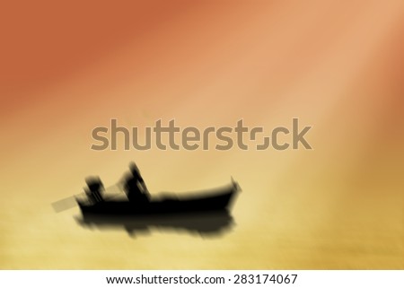 Blur Silhouette fishing boat at sea sunset background.