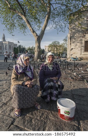ISTANBUL, TURKEY - MAY 17, 2011: Two women, wearing the hijab, seat next to each other, on a park, in Istanbul, Turkey, on May 17, 2011, and rest.