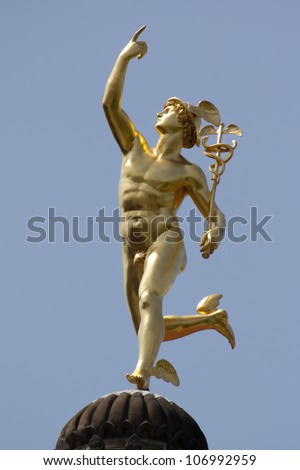 STUTTGART, GERMANY - JUNE 30: The statue of the Roman God Mercury made by the German sculptor Ludwig von Hofer in 1862, on top of the Old Chancellary Building on June 30, 2012 in Stuttgart, Germany.