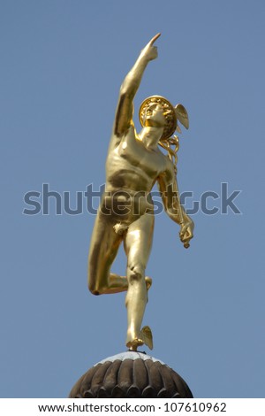STUTTGART, GERMANY - JUNE 30: The Roman God Mercury statue made by the German sculptor Johann Ludwig von Hofer in 1862, on top of the Old Chancellery Building on June 30, 2012 in Stuttgart, Germany.