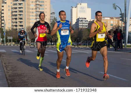 VALENCIA, SPAIN - JANUARY 12, 2014: Runners compete in the 10K Divina Pastora Valencia run. Over 10,500 people participated in the run.