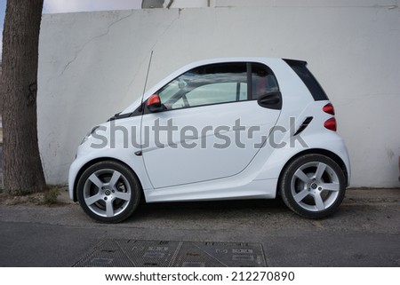 VALENCIA, SPAIN - AUGUST 20, 2014: A Smart Car parked in the street in Valencia, Spain.  The Smart Car is a small stylish city car with company headquarters in Germany, and the factory in France.