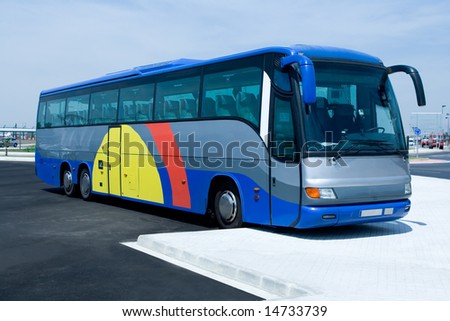 Blue tour bus in parking lot