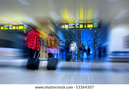 Airline passengers walking in the airport terminal