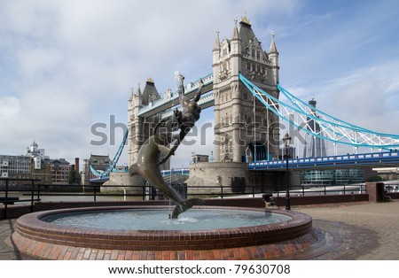 LONDON - May 30: The Tower Bridge and Girl Dolphin Statue on May 30, 2011 in London. The bridge's present color dates from 1977 when it was painted red, white and blue for the Queen's Silver Jubilee.