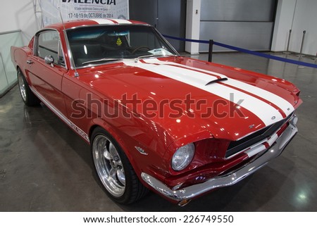 VALENCIA, SPAIN - OCTOBER 17, 2014: A red 1965 Ford Mustang Fast Back at the Retro Auto and Moto Valencia Classic Car Show. The first generation Mustang was produce between the years 1964 and 1973.