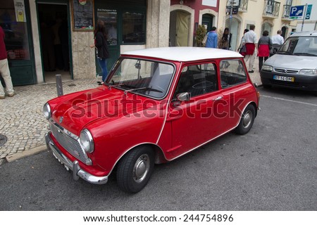 LISBON, PORTUGAL - MAY 28, 2014: A Classic Mini Cooper car parked in the street in Lisbon.  In 1999 the Mini was voted the second most influential car of the 20th century, behind the Ford Model T.
