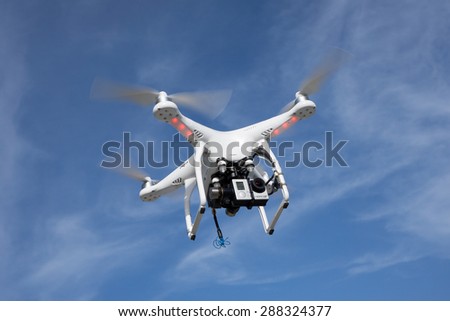 JACKSONVILLE, FL. USA - JUNE 14, 2015: A DJI Phantom consumer drone flying in the sky with a GoPro Hero 3 action camera. The global market for consumer drones is forecast to top $300 million by 2018.