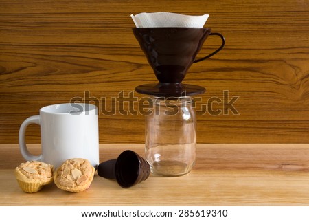 coffee drip glass pitcher on old wooden background