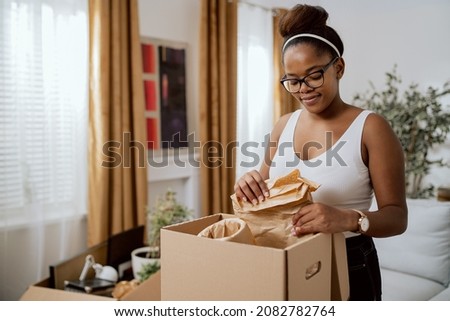 Similar – Foto Bild Frau beim Auspacken einer Kiste mit Trainingsgeräten zu Hause