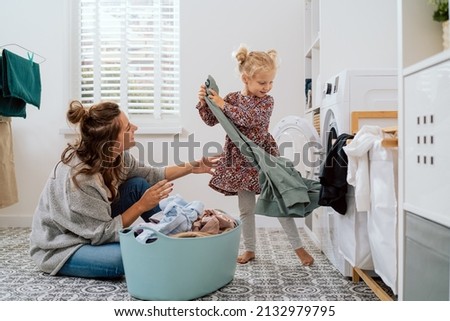 Image, Stock Photo Mother doing the laundry together with her young child