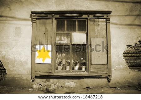Holocaust sign. Old window and yellow star of David
