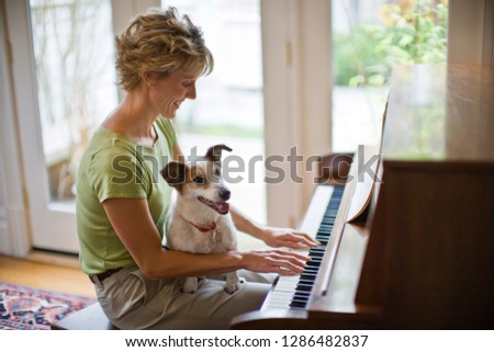 Similar – Image, Stock Photo Smiling woman playing piano in living room