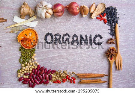 Organic label with various ingredients frame on wooden table