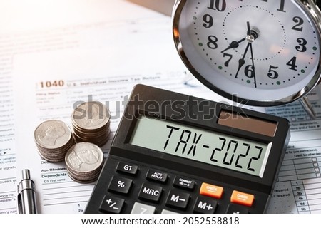 Tax word and 2021 number displayed on a calculator. Business and tax concept. Pay tax in 2022 years. The new year 2022 tax concept