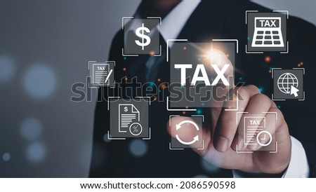Business hand clicks virtual screen to tax return online for tax payment by corporations such as VAT, income tax, and property tax. 