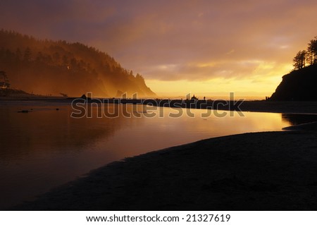 Golden glow of a misty sunset at the mouth of Neskowin Creek on the Pacific Coast of Oregon.