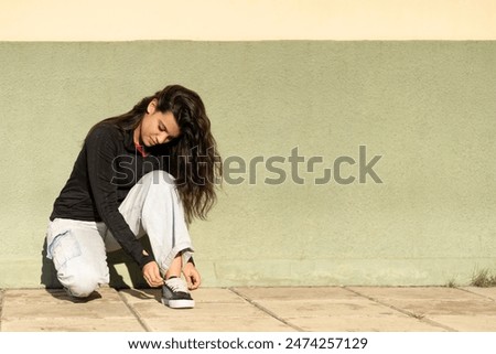 Similar – Image, Stock Photo A teenage girl ties her shoelaces in sneakers, prepares for training