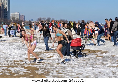 CHICAGO, IL - FEBRUARY 7: Swimmers exit the water at the Lakeview Polar Bear Club\'s 8th Annual polar plunge on February 7, 2009 at Oak Street Beach in Chicago, IL
