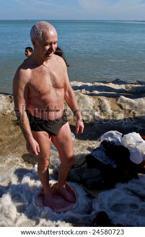 CHICAGO, IL - FEBRUARY 7: A swimmer warms following the Lakeview Polar Bear Club\'s 8th Annual polar plunge on February 7, 2009 at Oak Street Beach in Chicago, IL