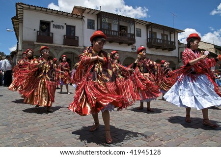 CUZCO, PERU - OCTOBER 8: Women in traditional red dresses and hats dance in the Virgen del Rosario Festival near the Plaza de Armas in Cuzco, Peru on October 8, 2009