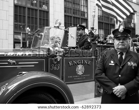 NEW YORK CITY - OCTOBER 11: An official stands in front of his fire truck at the Columbus Day Parade on Fifth Avenue on October 11, 2010 in New York City.
