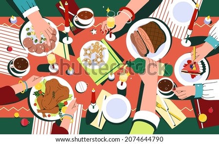 Christmas festive dinner with hands of people, decorated table top view. Delicious traditional holiday dishes on plates. Flat family celebrating thanksgiving day and eating delicious food together.