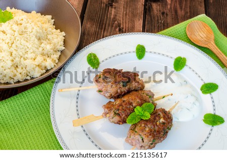 Beef kebab with coriander, garlic, couscous and mint dip