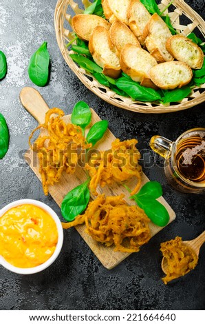 Crispy Onion Bhajis with creame cheese dip with jalapeno and crunchi toast on spinach leaves and czech beer