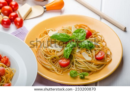 Lemon pasta with cherry tomatoes, basil and nuts, 2 plates, various serving